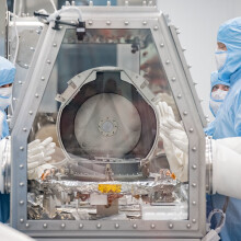 Scientists opening the OSIRIS-REx asteroid sample return lid at the NASA Johnson Space Center 