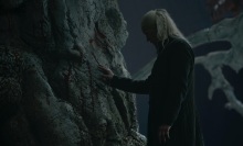 Daemon Targaryen places his hand on the white weirwood at Harrenhal.