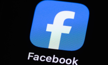 The logo of the Facebook application app from the US company Meta can be seen on the display of an iPhone.