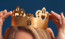 a woman's hands and the top of her head as she touches her crypto crown