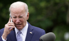 U.S. President Joe Biden talks on a cell phone during a Rose Garden event at the White House to mark National Small Business Week on May 1, 2023 in Washington, DC.