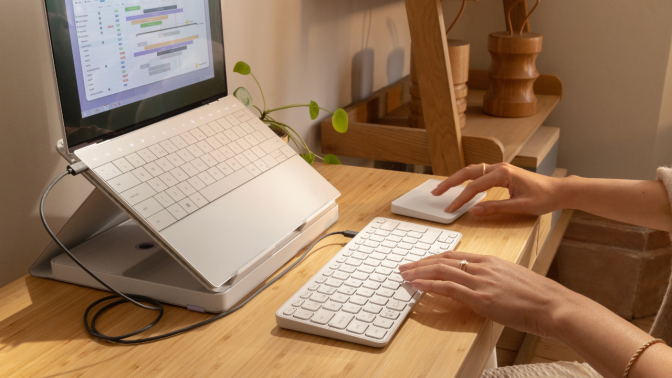 desk set up with casa pop-up stand, keyboard, and trackpad