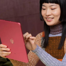 A person holding a pink iPad