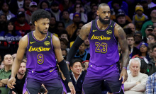 Bronny James #9 stands by LeBron James #23 of the Los Angeles Lakers during the second half against the Philadelphia 76ers at the Wells Fargo Center on January 28, 2025 in Philadelphia, Pennsylvania.