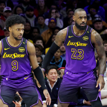 Bronny James #9 stands by LeBron James #23 of the Los Angeles Lakers during the second half against the Philadelphia 76ers at the Wells Fargo Center on January 28, 2025 in Philadelphia, Pennsylvania.