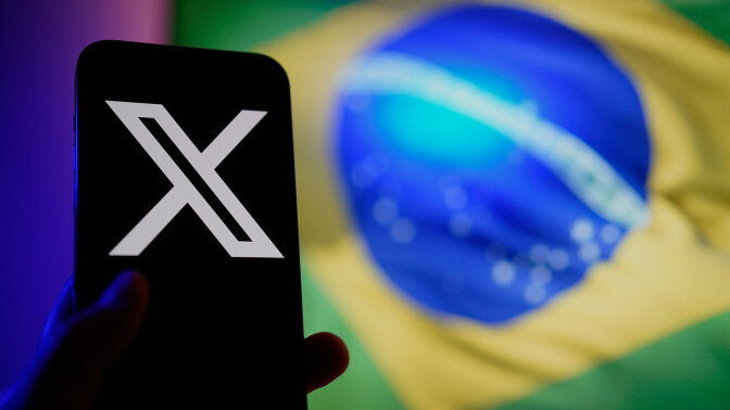 A smartphone shows the X logo. In the background the Brazilian flag is visible.