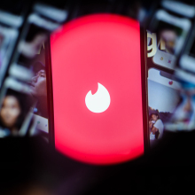 A photo illustration of the dating app Tinder on iPhone screen