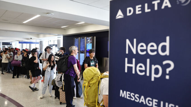 "Need Help?" sign at Delta Airlines check-in counter at airport