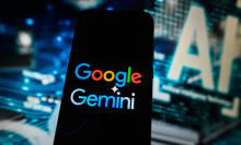 A Google Gemini logo is displayed on a smartphone with Artificial Intelligence symbol on the background.