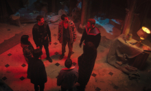 Seven people stand in a circle in a dilapidated house in "The Umbrella Academy."