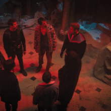 Seven people stand in a circle in a dilapidated house in "The Umbrella Academy."