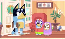 Bandit holding a clipboard while Bluey and Bingo are dressed as grannies in 'Bluey.'