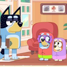 Bandit holding a clipboard while Bluey and Bingo are dressed as grannies in 'Bluey.'