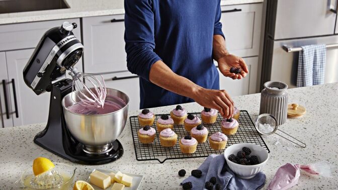 A person makes cupcakes with the KitchenAid mixer
