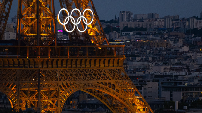 The Eiffel Tower lit up with the Olympic rings.