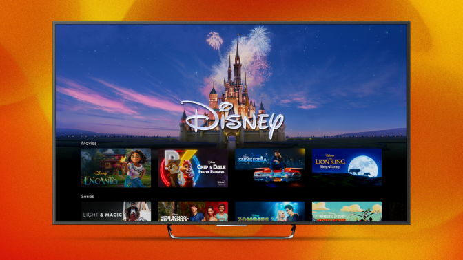 a tv displaying the disney+ interface in front of an orange and yellow abstract background