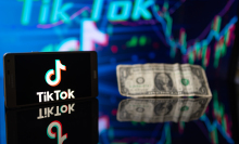 a smartphone showing the TikTok logo, and a dollar.