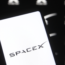 A Spacex logo is seen on a smartphone.