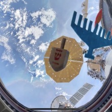 Astronaut spinning dreidel in space