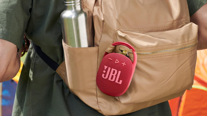 A JBL Clip 4 speaker attached to a backpack
