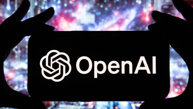 The OpenAI logo on a smartphone against the backdrop of colorful light flares