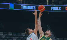 Australia and Serbia reach for the basketball