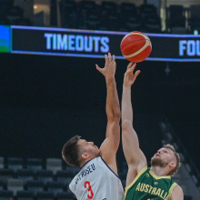 Australia and Serbia reach for the basketball