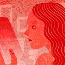 woman looking at her phone; entire image is red-tinted