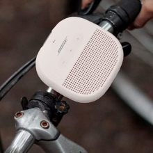 beige bose speaker on bike handle