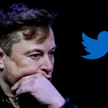Elon Musk looking pensive next to a Twitter icon