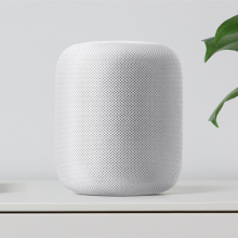 Apple HomePod sitting on a shelf.