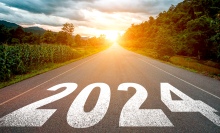 2024 written on a road heading towards the sun.