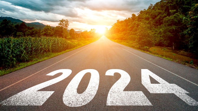 2024 written on a road heading towards the sun.