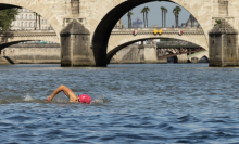 A local resident swims in the Seine