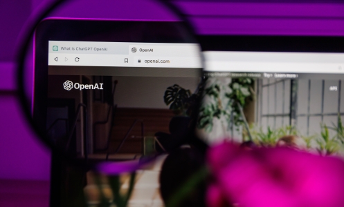 ChatGPT OpenAI website through magnifying glass on screen