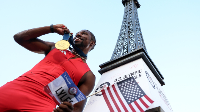 Noah Lyles celebrates with the gold medal