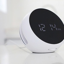 Desktop Wireless Charger with Alarm Clock on a table.