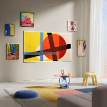 A TCL TV mounted on the wall and showing abstract art