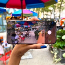 Woman holding iPhone 16 Pro Max inside Bryant Park