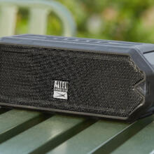 Small black speaker on a green table