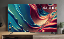 TCL 4K TV with colorful abstract liquid screensaver sitting on TV stand