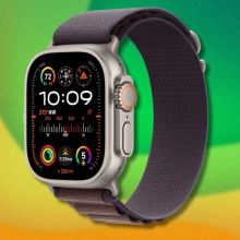 An Apple Watch Ultra model superimposed on a rainbow background