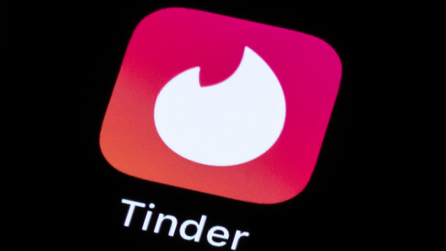 tinder logo displayed on smart phone