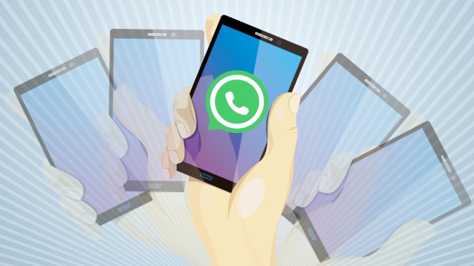 A graphic of phone screens with the WhatsApp logo in the middle.