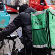 A delivery driver on a bike in London.