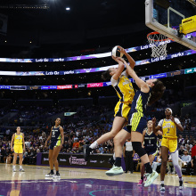 : Dearica Hamby #5 of the Los Angeles Sparks is fouled by Maddy Siegrist #20 of the Dallas Wings