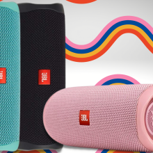 jbl flip 5 speakers in black, pink, and teal with rainbow striped background