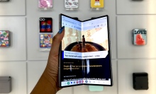 A woman holding the Samsung Galaxy Z Fold 6