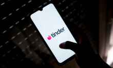 Tinder logo on phone screen