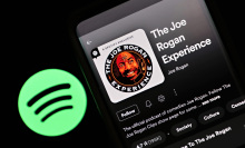 In this photo illustration, "The Joe Rogan Experience" podcast is viewed on Spotify's mobile app